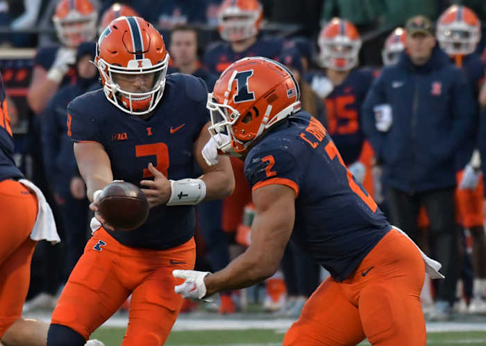 Nov 5, 2022; Champaign, Illinois, USA; Illinois Fighting Illini quarterback Tommy DeVito (3) hands the ball to running back Chase Brown (2) during the second half at Memorial Stadium. Mandatory Credit: Ron Johnson-USA TODAY Sports